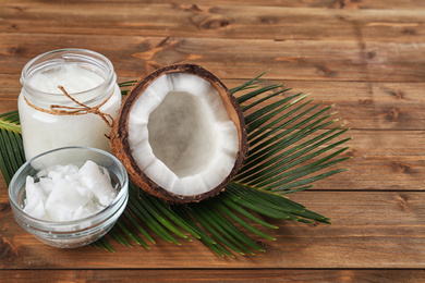 Photo of Composition with organic coconut oil on wooden table. Healthy cooking