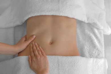 Photo of Woman receiving professional belly massage, closeup view