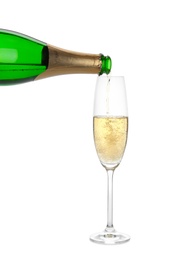 Pouring champagne from bottle into glass on white background. Festive drink