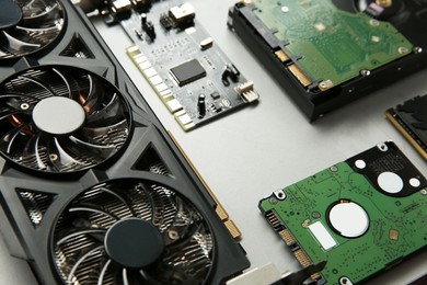 Photo of Graphics card and other computer hardware on gray background, closeup