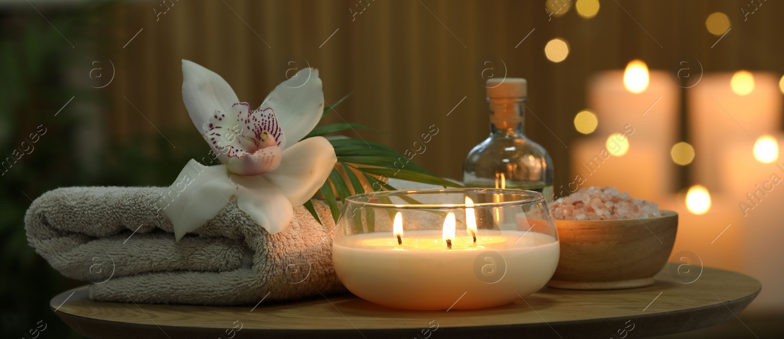 Photo of Composition with different spa products and orchid flower on wooden table