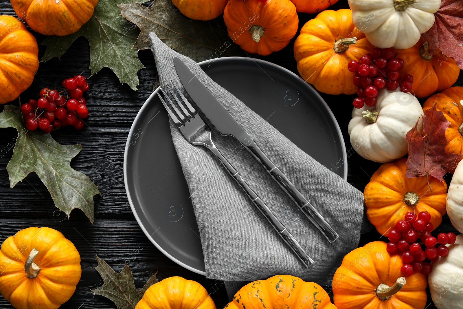 Photo of Happy Thanksgiving day. Beautiful table setting with autumn leaves, berries and pumpkins, flat lay