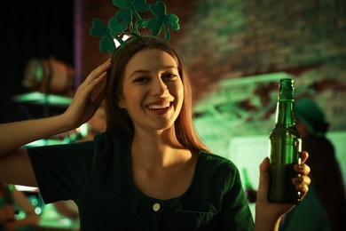 Photo of Woman with beer celebrating St Patrick's day in pub