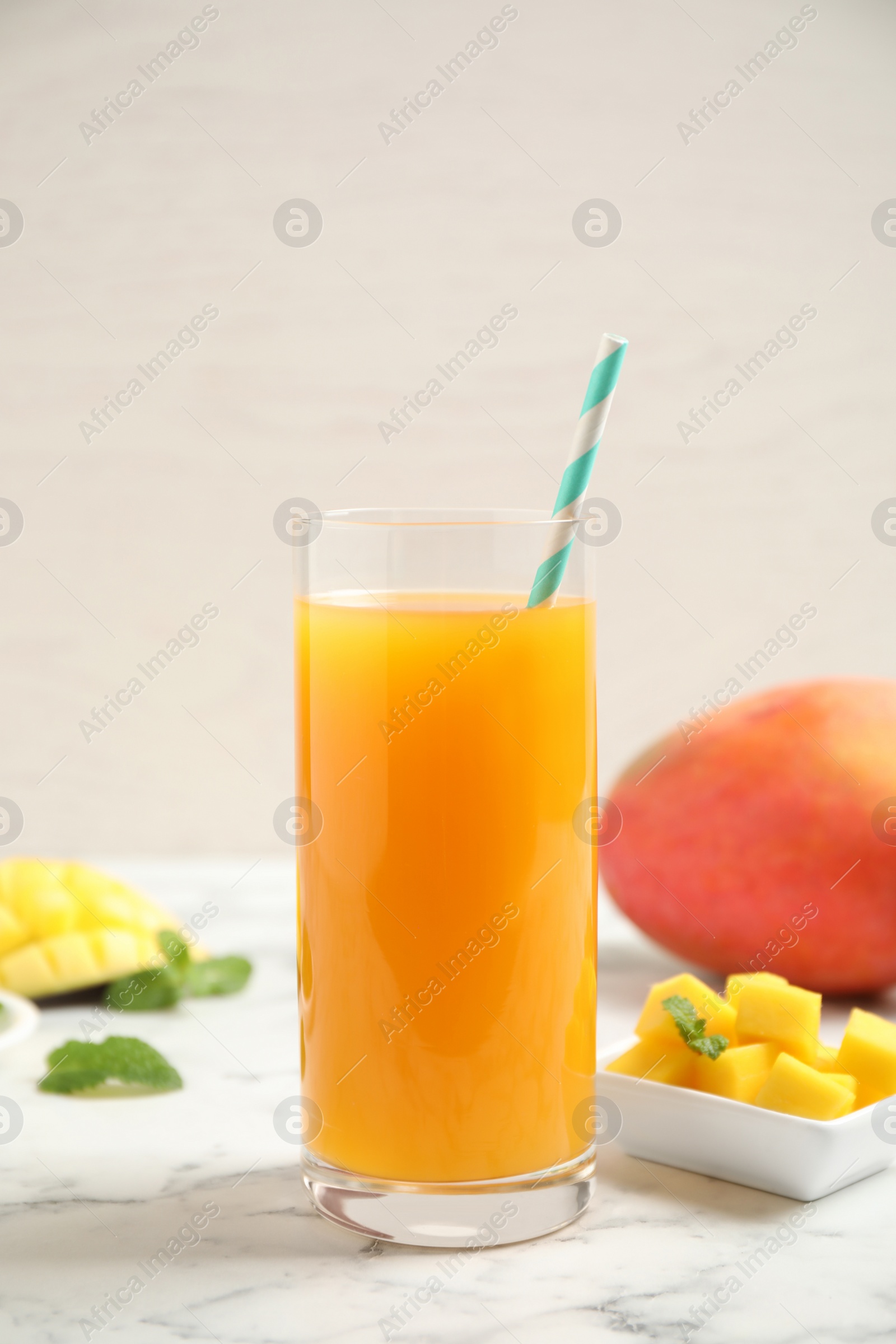 Photo of Fresh delicious mango drink on marble table