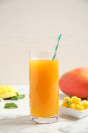 Fresh delicious mango drink on marble table