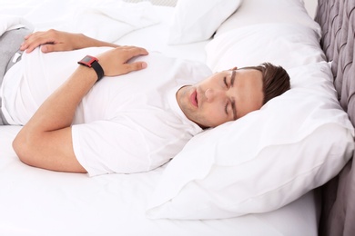 Photo of Young man sleeping in bed at home