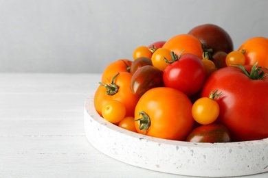 Photo of Fresh ripe tomatoes on white wooden table