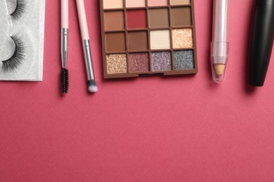 Set of makeup products on pink background, flat lay. Space for text