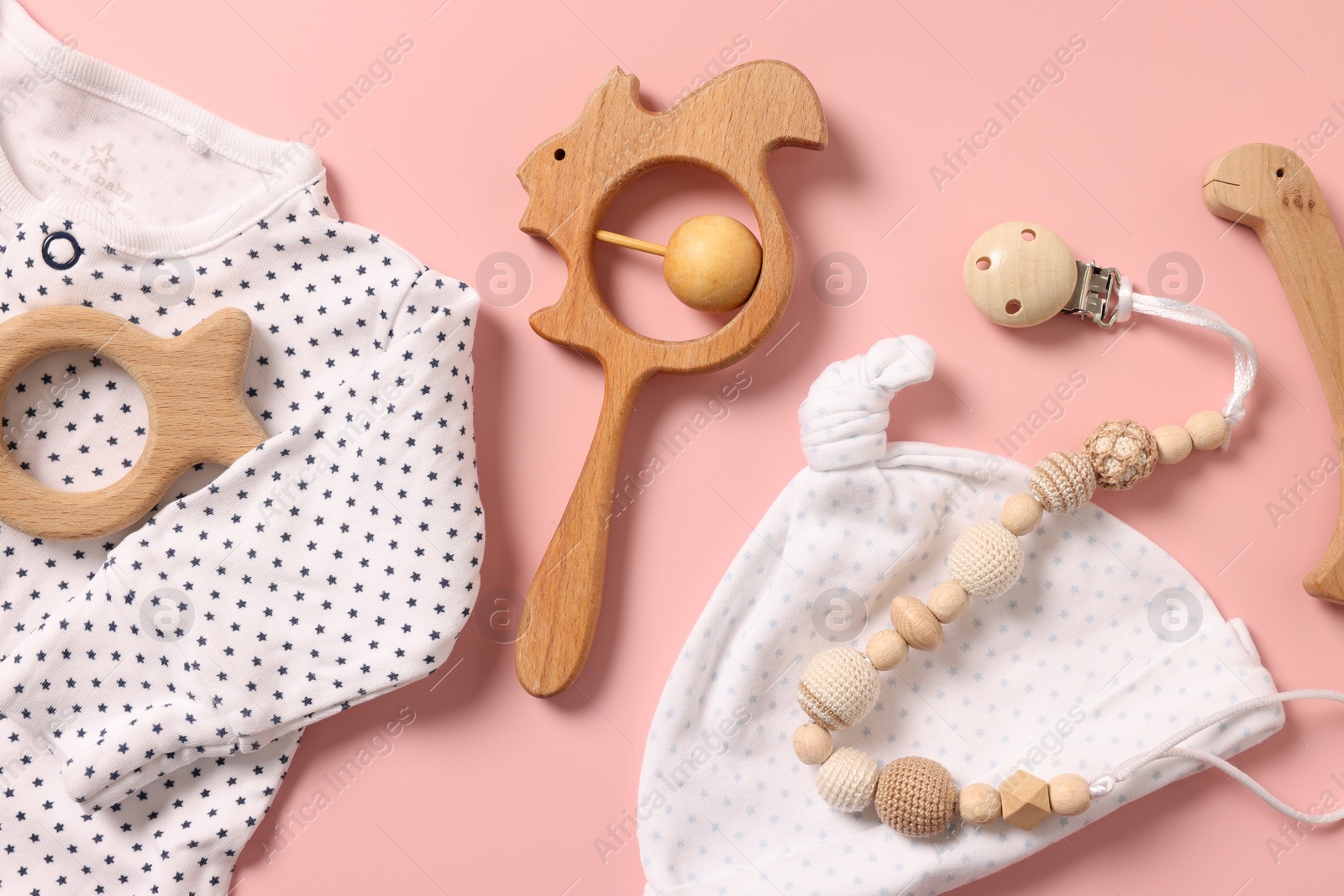 Photo of Different baby accessories on pink background, flat lay