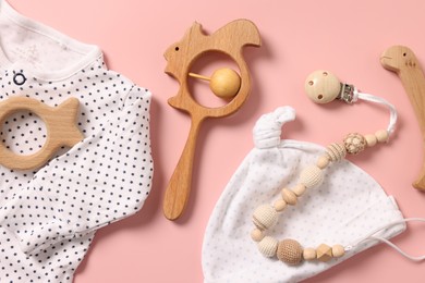 Different baby accessories on pink background, flat lay