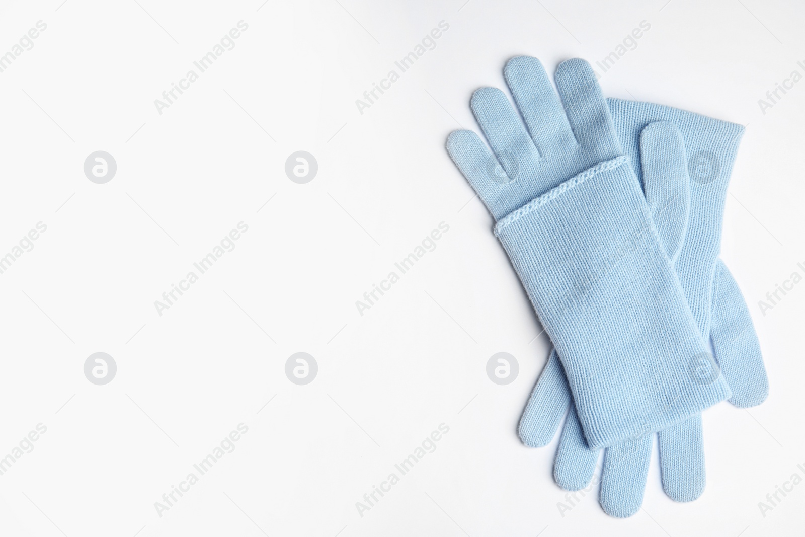 Photo of Stylish blue gloves on white background, top view with space for text. Autumn clothes