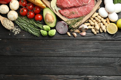 Photo of Flat lay composition with fresh meat and other products on wooden table, space for text. Balanced diet