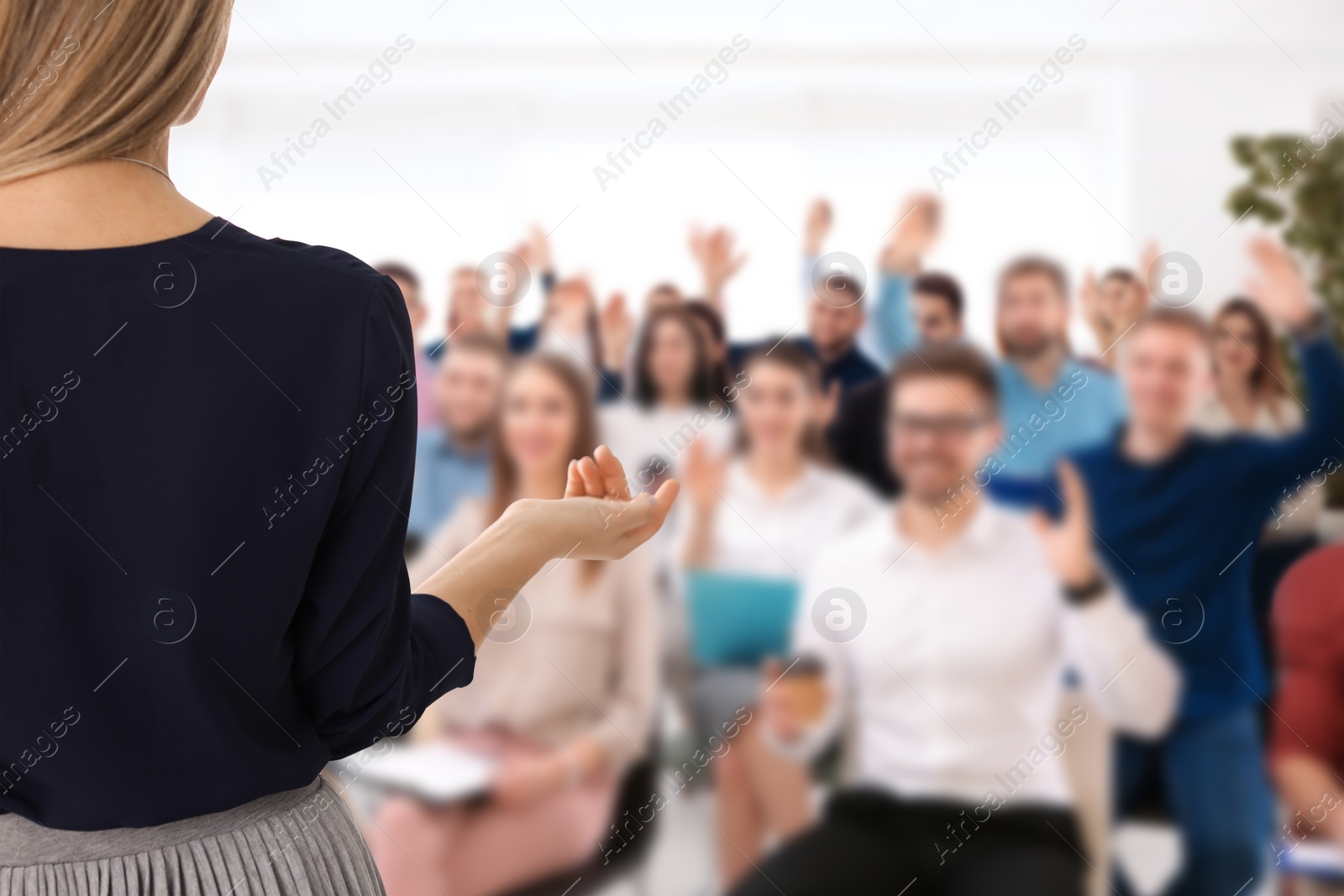 Image of Motivational speaker giving speech in office, closeup view