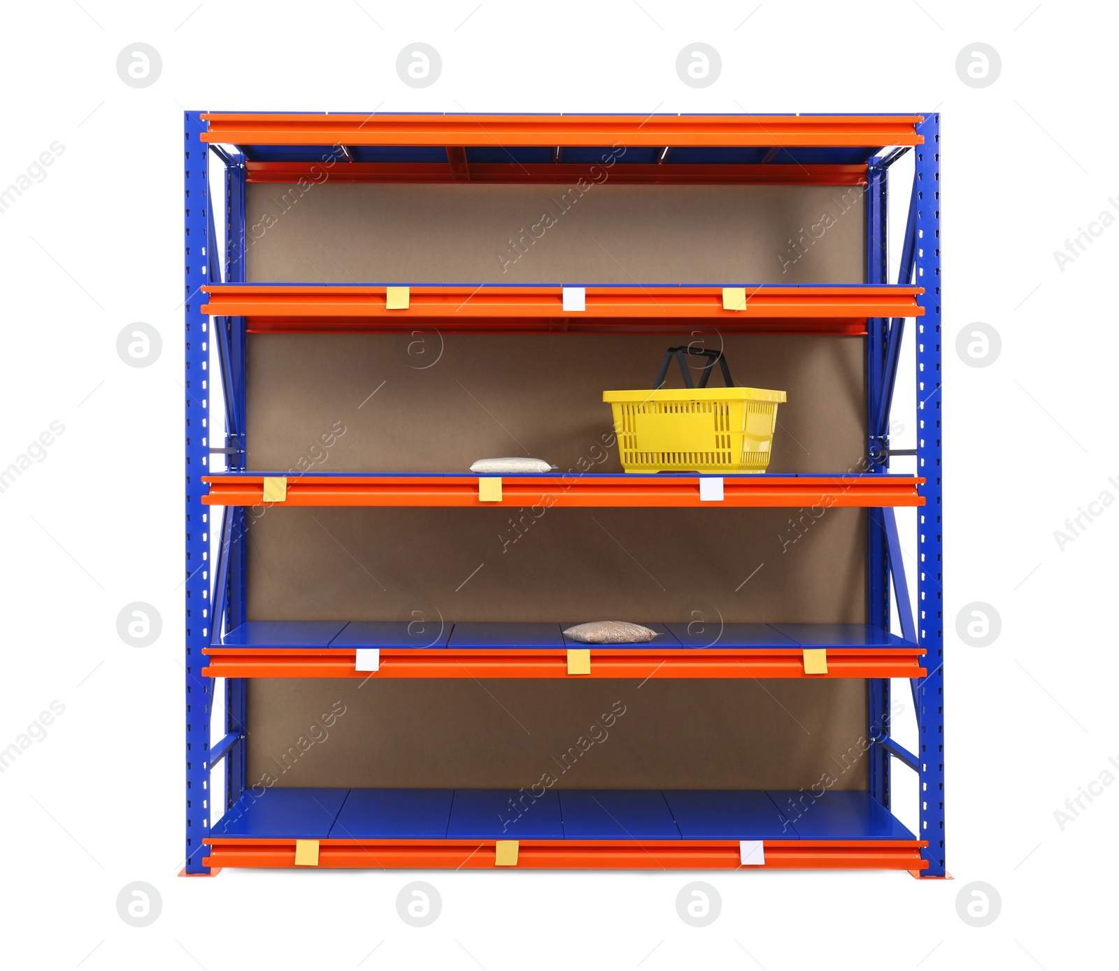Photo of Shelves with price labels, shopping basket and groats isolated on white. Panic during coronavirus pandemic