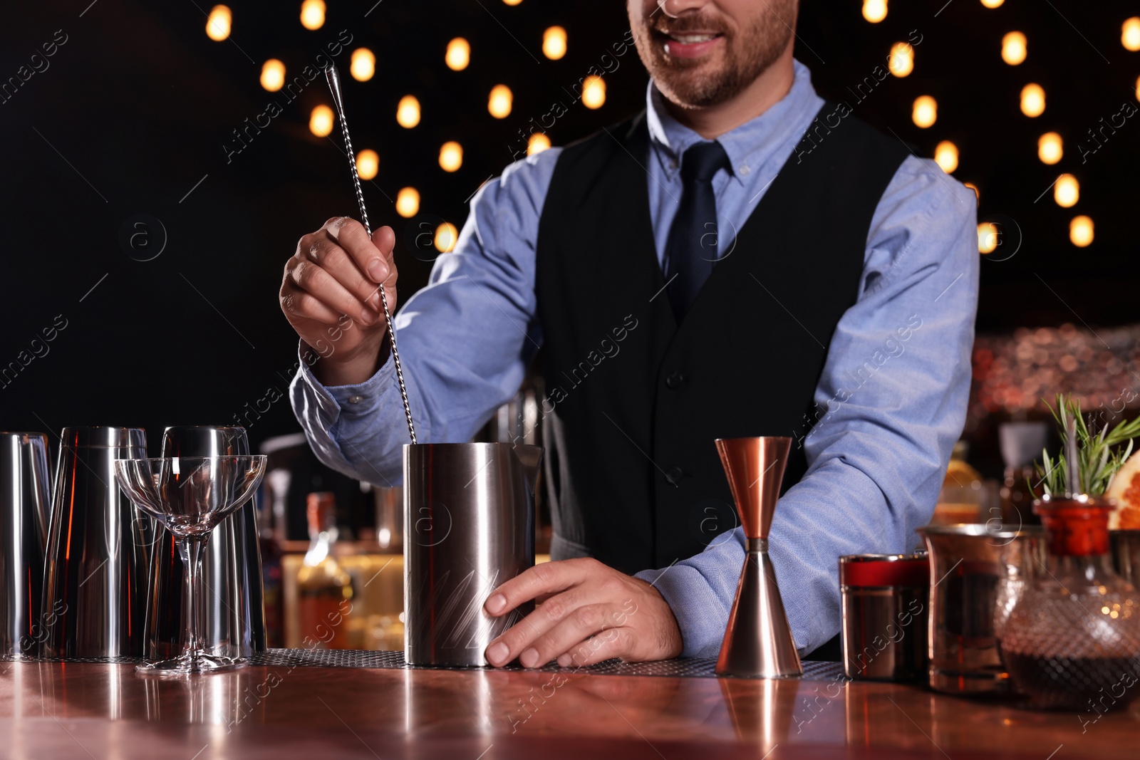 Photo of Bartender preparing fresh alcoholic cocktail in bar, closeup