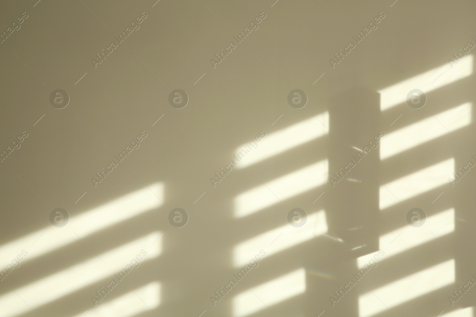 Photo of Lines made of light and shadows on white wall