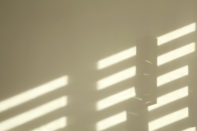 Photo of Lines made of light and shadows on white wall