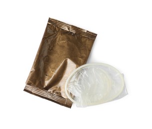 Photo of Unpacked female condom and torn package isolated on white, top view. Safe sex
