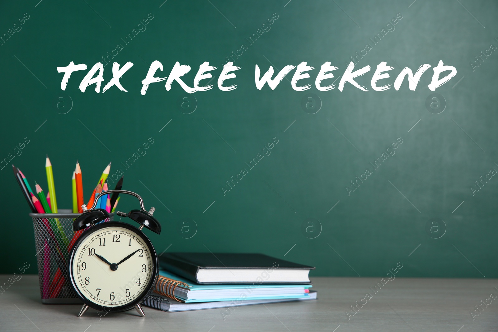 Image of School stationery and text TAX FREE WEEKEND written on chalkboard in classroom