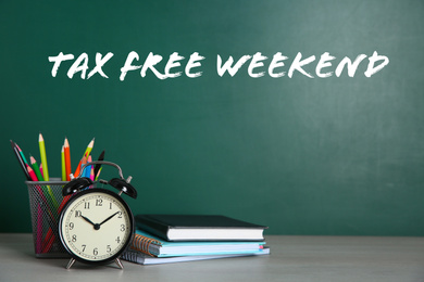 Image of School stationery and text TAX FREE WEEKEND written on chalkboard in classroom