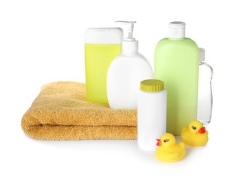 Photo of Bottles of baby cosmetic products, towel and rubber ducks on white background