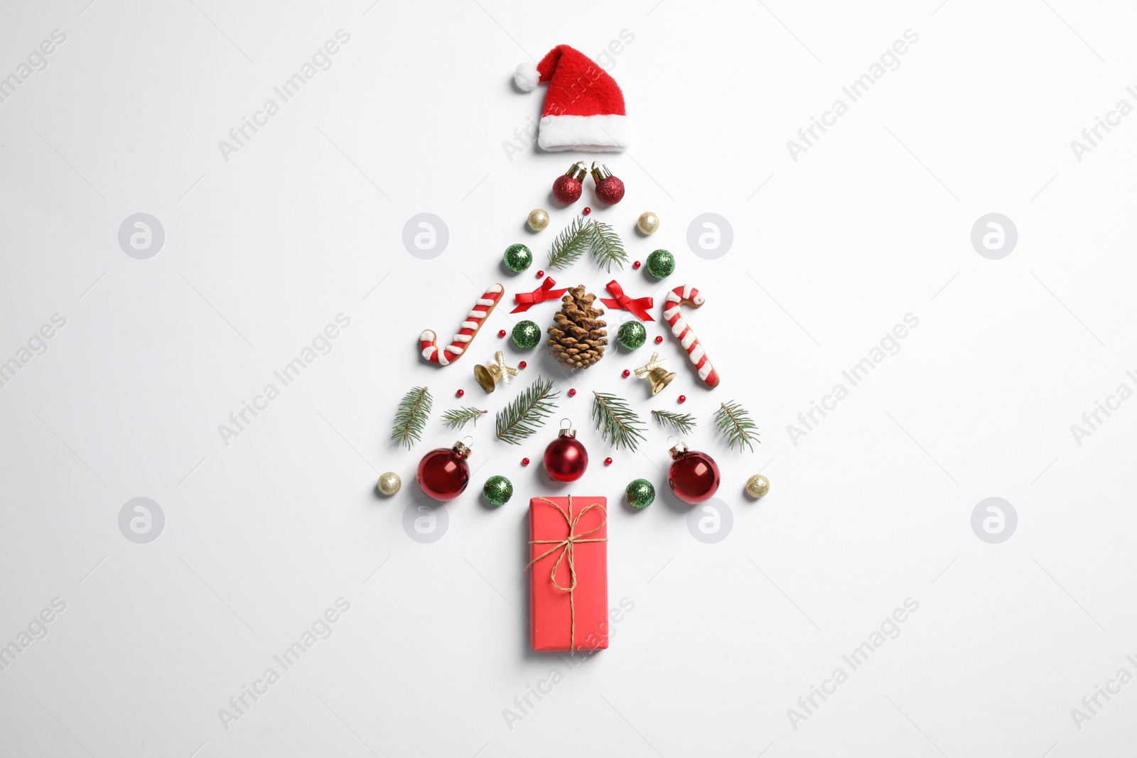 Photo of Christmas tree silhouette of fir branches and festive decoration on white background, top view