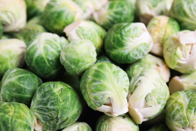 Photo of Fresh tasty Brussels sprouts as background, closeup