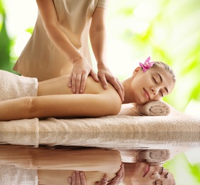 Image of Beautiful young woman enjoying massage. Spa treatment