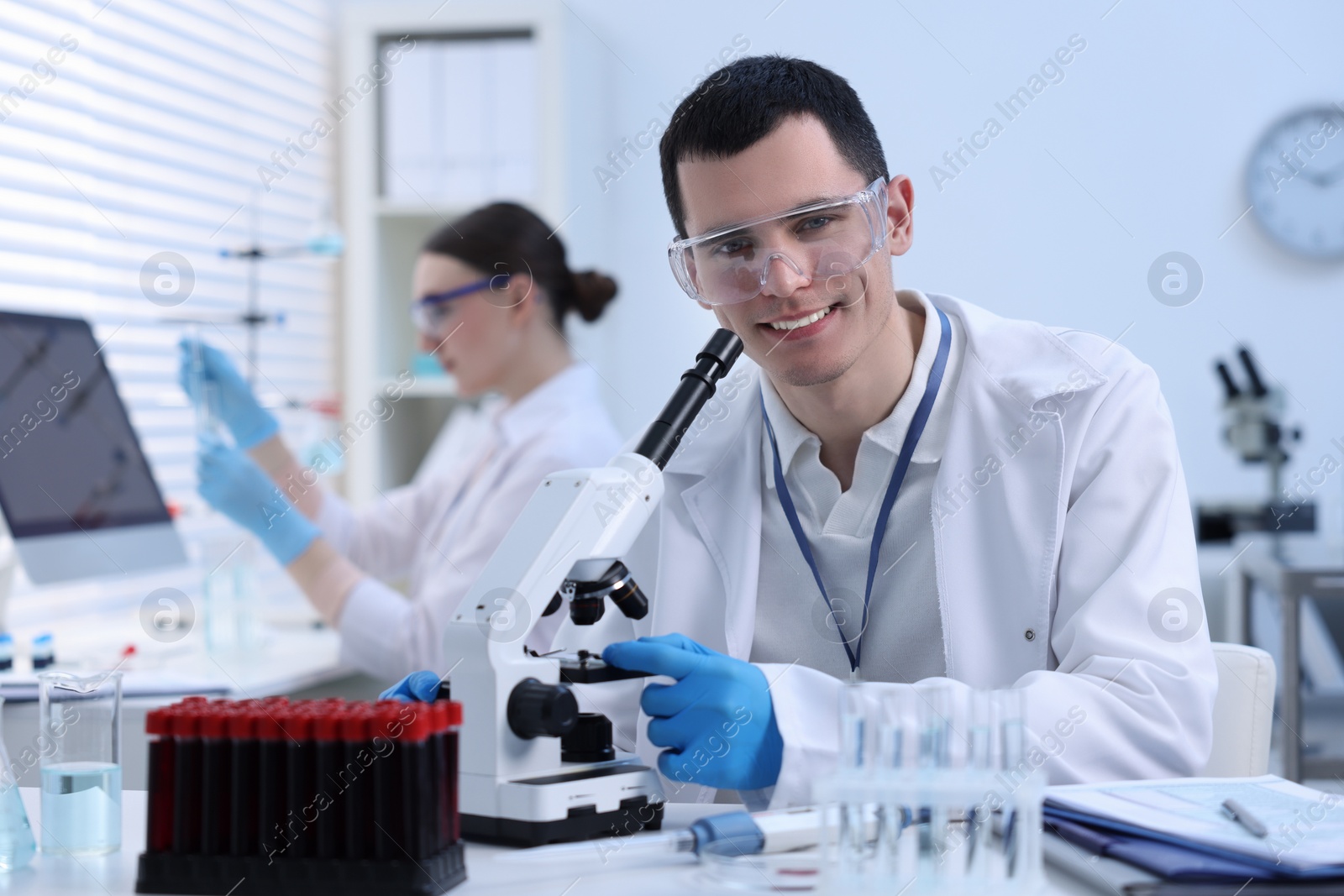 Photo of Scientist working with microscope in laboratory. Medical research