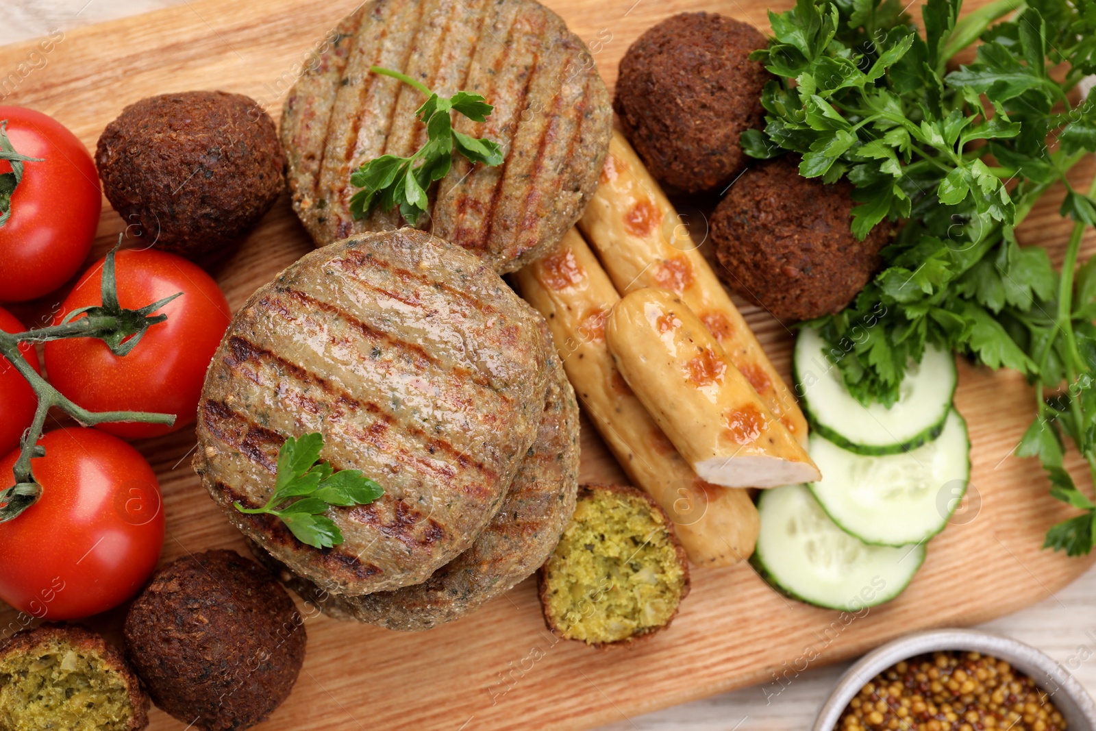 Photo of Different tasty vegan meat products and fresh vegetables on wooden table, flat lay