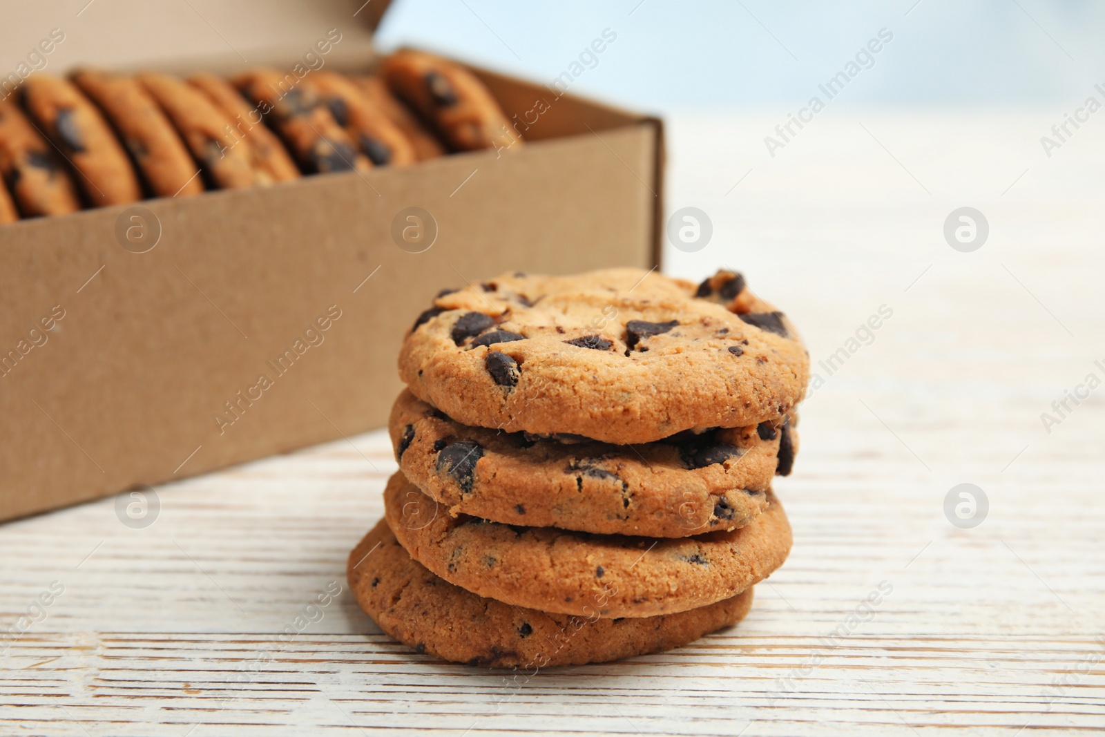 Photo of Delicious chocolate chip cookies on wooden table