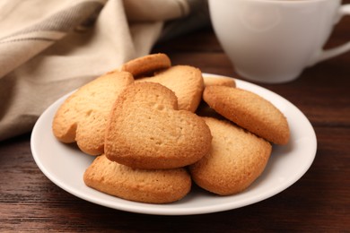 Heart shaped Danish butter cookies on wooden table, closeup