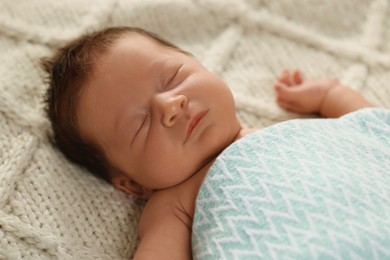 Photo of Cute newborn baby sleeping on beige blanket, closeup