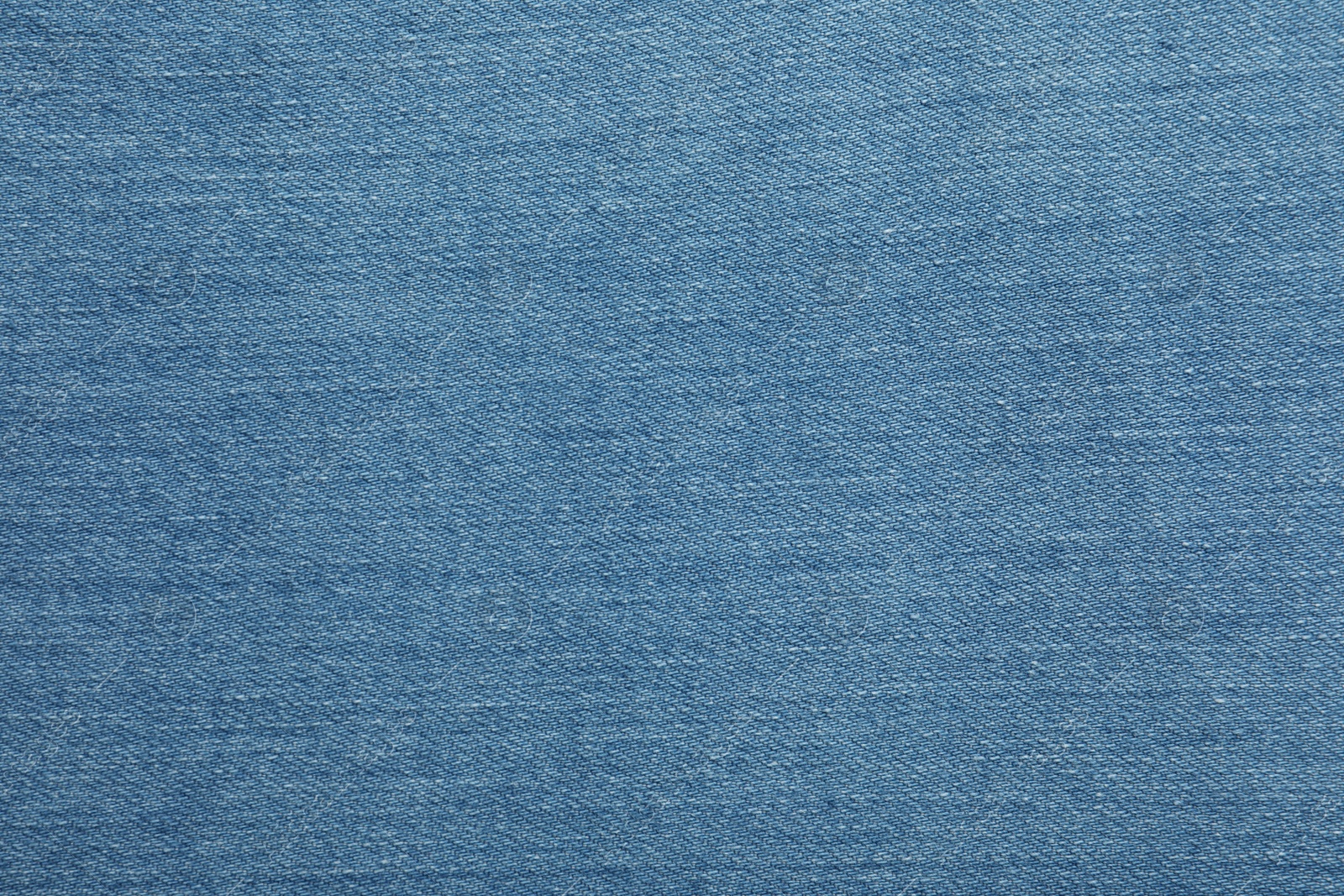 Photo of Texture of blue jeans as background, closeup