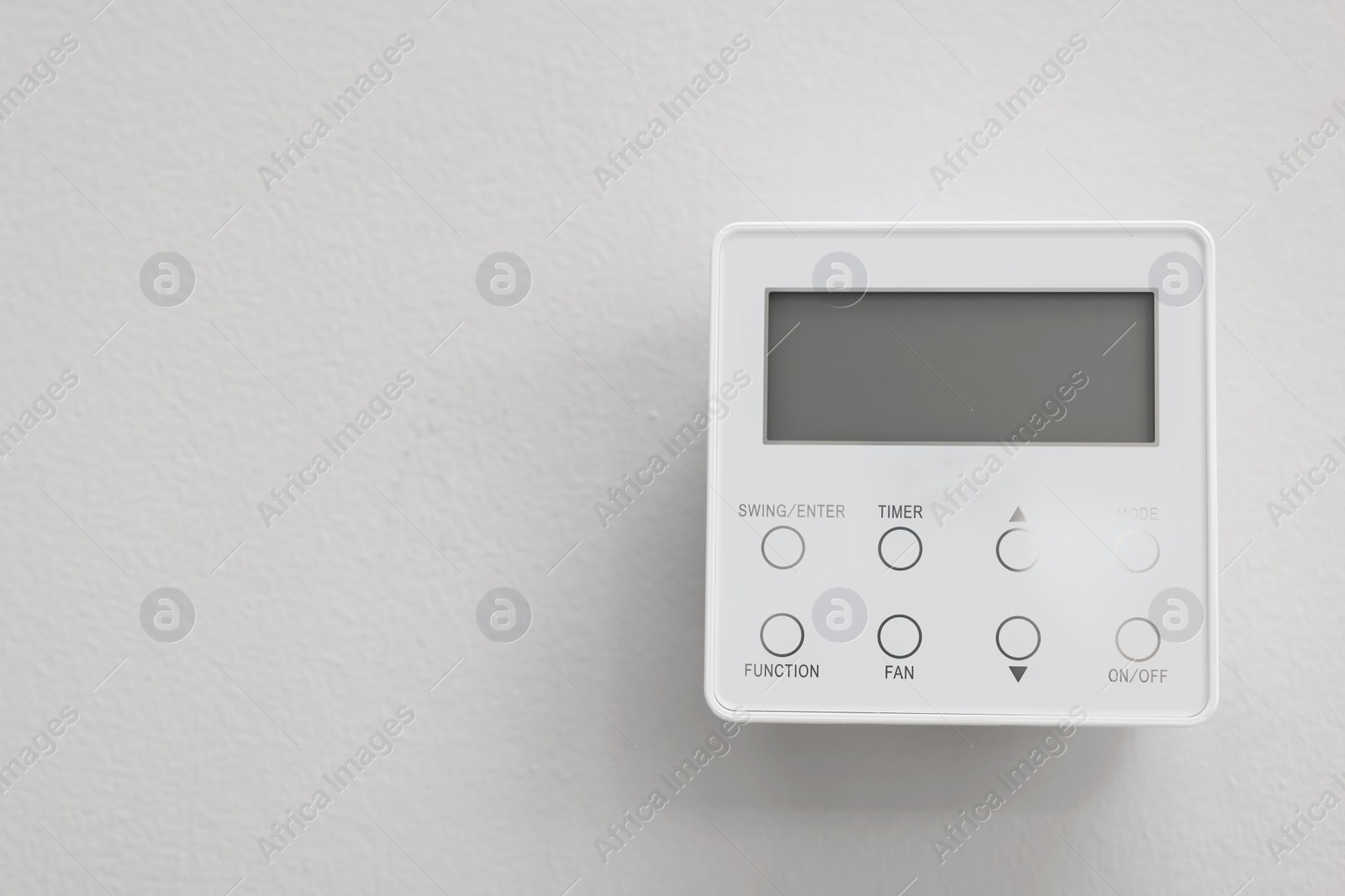 Photo of One thermostat on white wall indoors, space for text. Smart home system