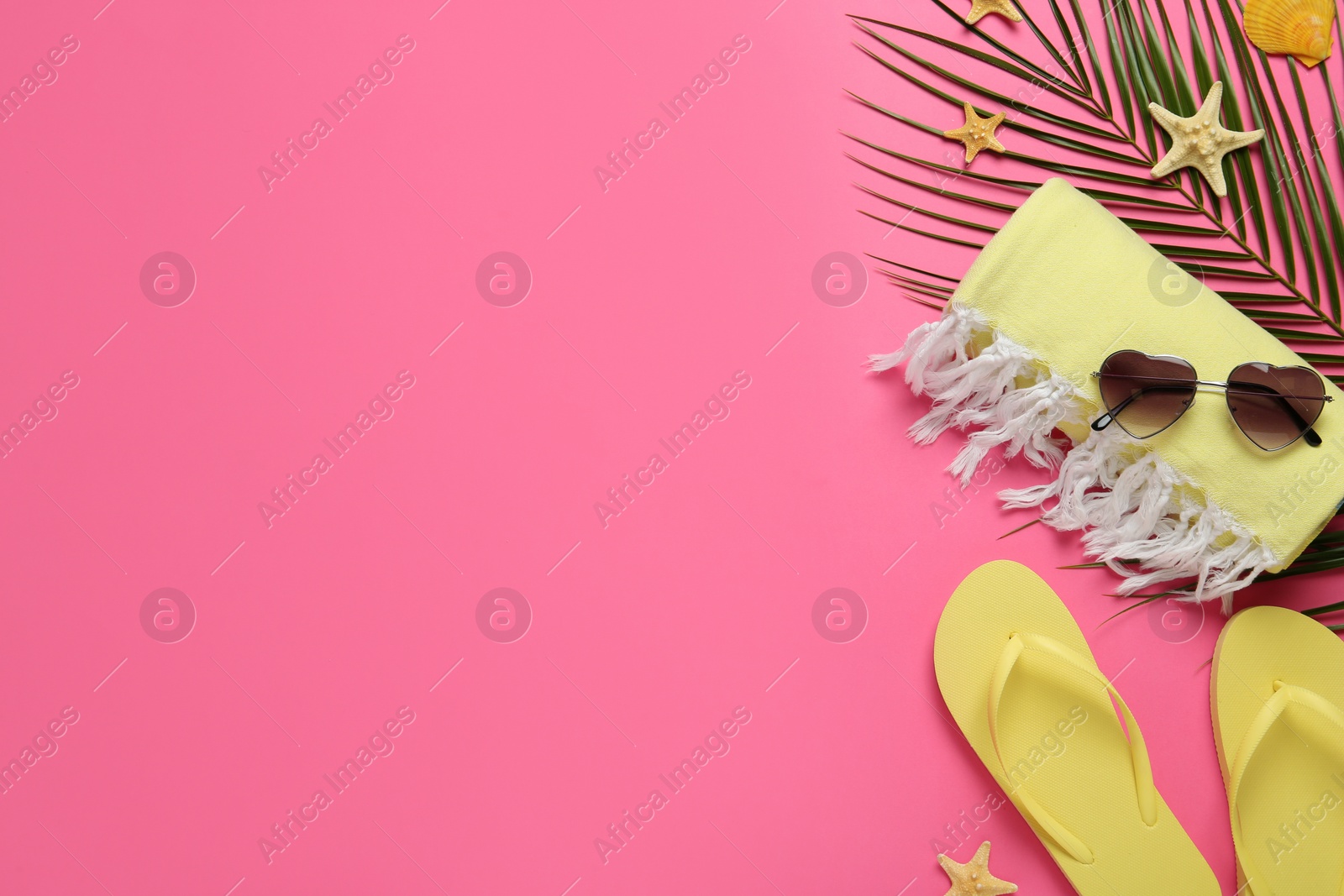 Photo of Flat lay composition with different beach objects on pink background, space for text