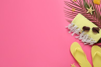 Photo of Flat lay composition with different beach objects on pink background, space for text