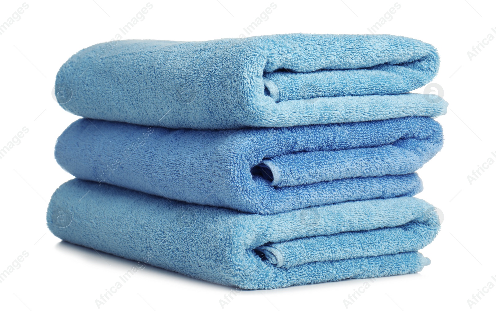 Photo of Folded soft terry towels on white background