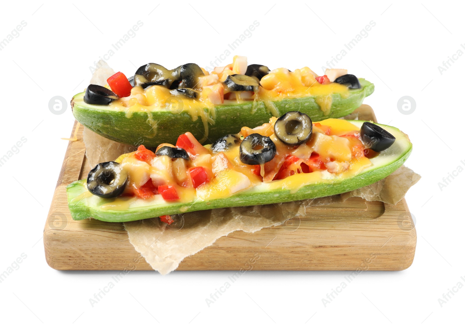 Photo of Wooden board with baked stuffed zucchinis on white background