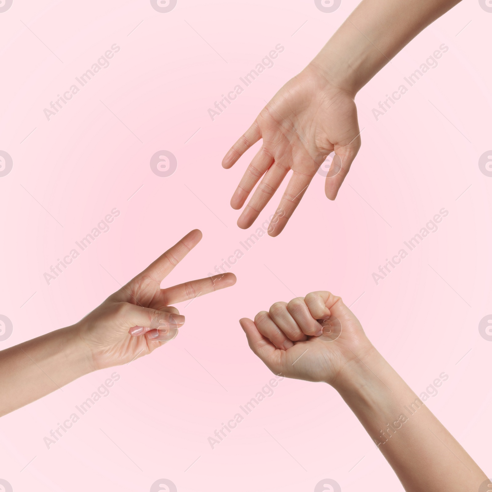 Image of People playing rock, paper and scissors on pink background, top view