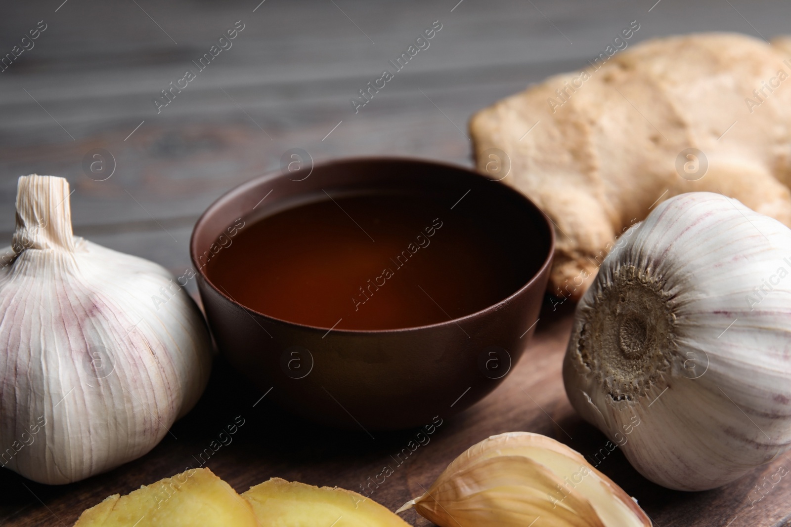 Photo of Fresh garlic and other natural cold remedies on table