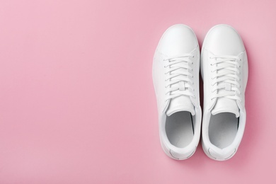 Photo of Pair of sneakers on color background, flat lay. Space for text