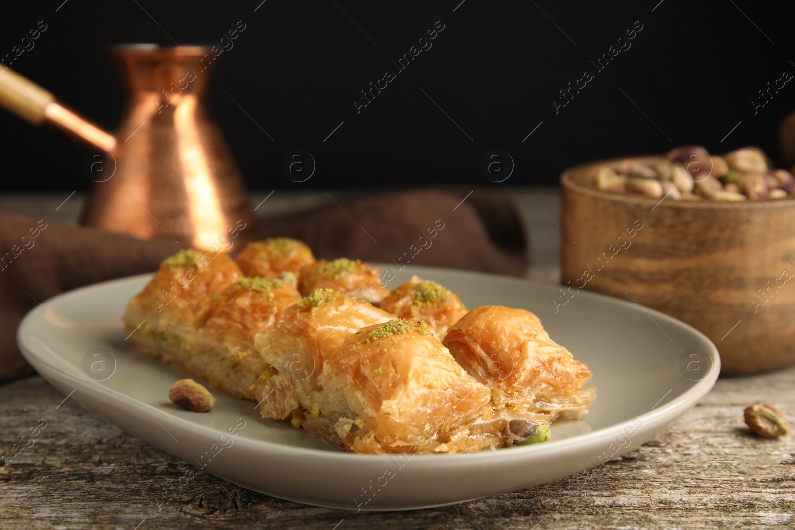 Photo of Delicious baklava with pistachios on wooden table