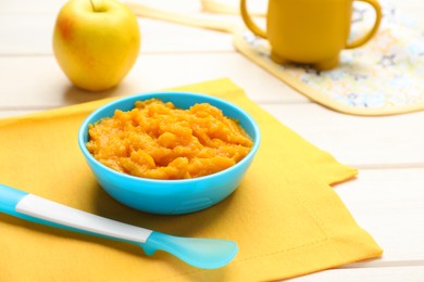 Photo of Plastic dishware with healthy baby food on white table