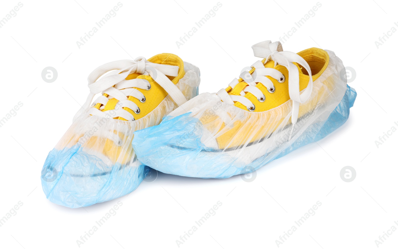 Photo of Sneakers in blue shoe covers isolated on white