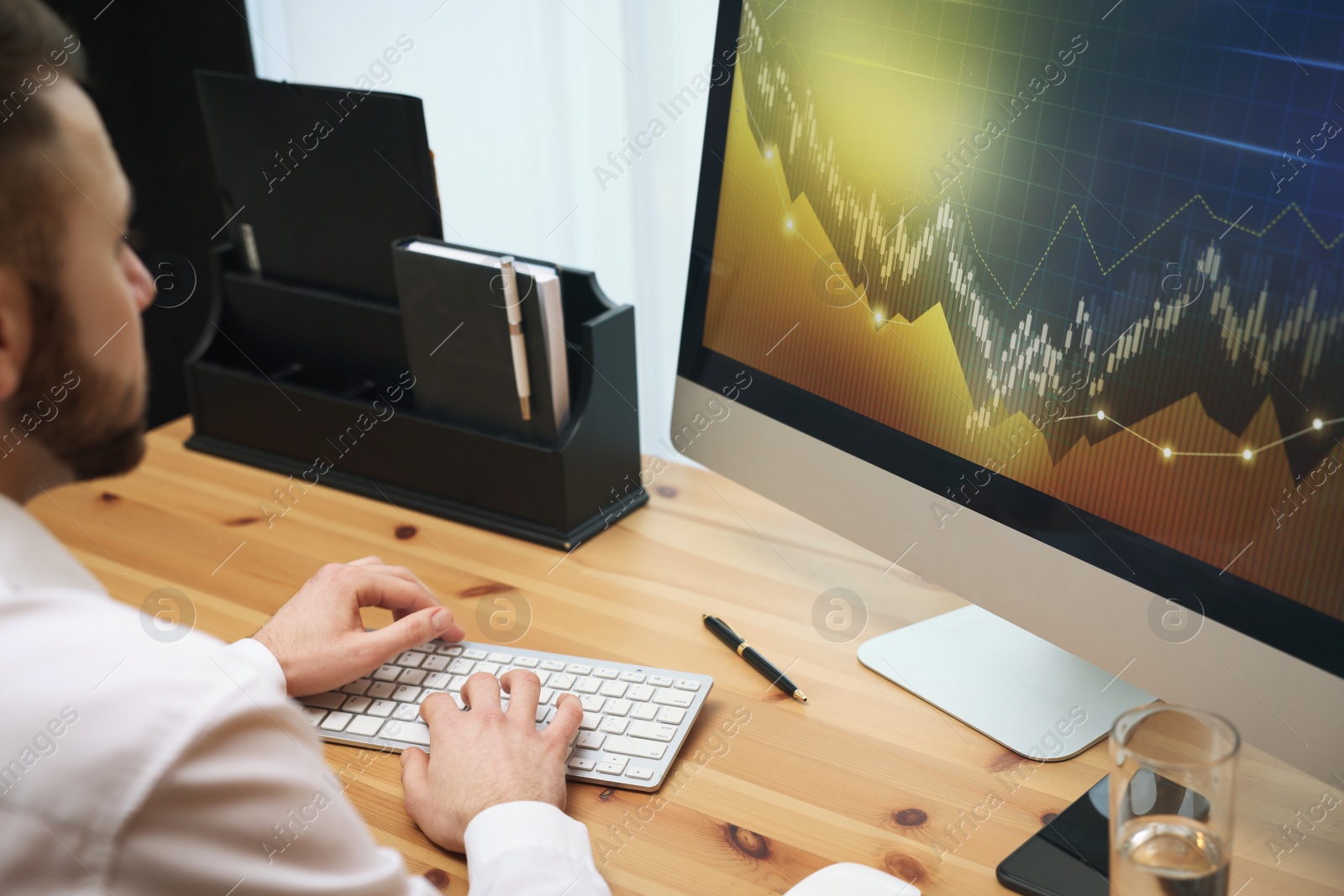 Photo of Forex trader working with computer in office