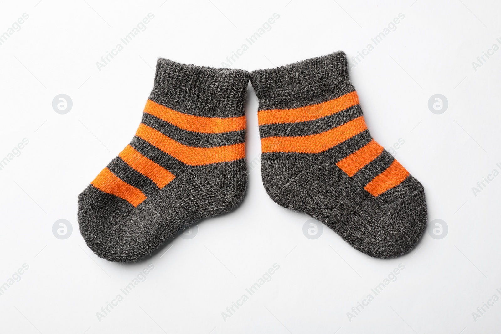 Photo of Cute child socks on white background, top view