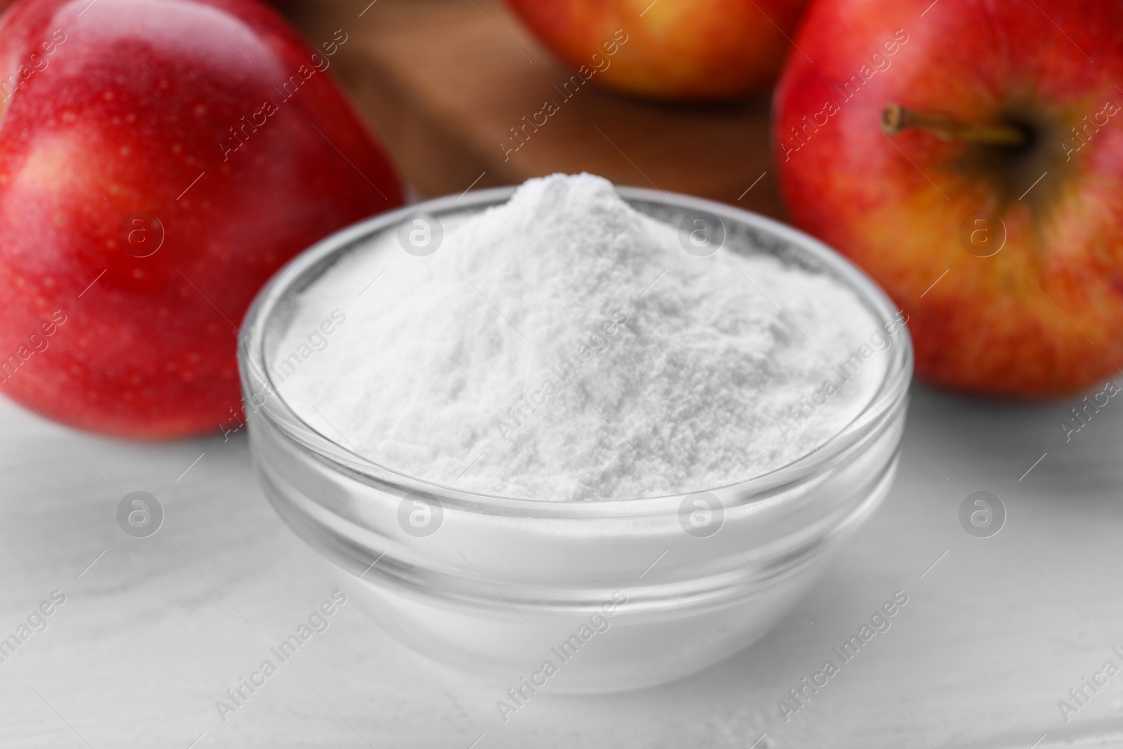 Photo of Sweet powdered fructose and fresh apples on white wooden table, closeup