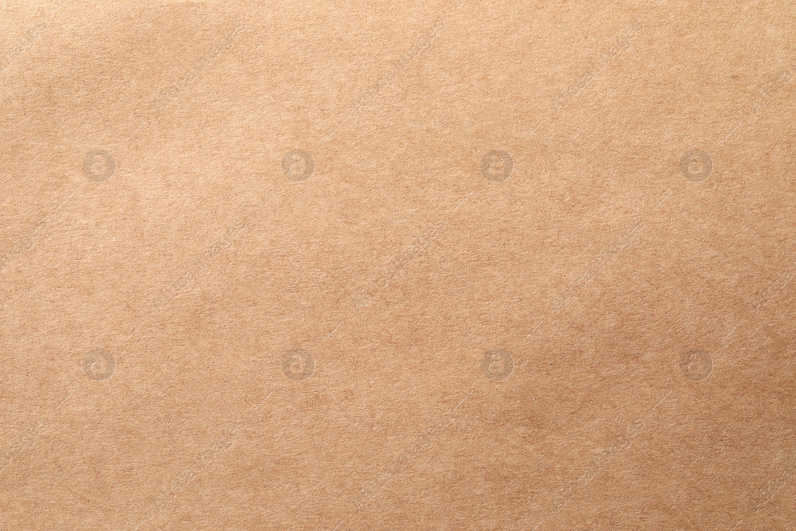 Photo of Texture of kraft paper sheet as background, closeup