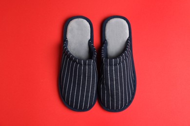 Photo of Pair of stylish slippers on red background, top view